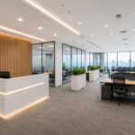 Modern office fit-out project in Dubai featuring a combined workspace created from two office units, including reception area, meeting room, open workstations, and manager cabin.
