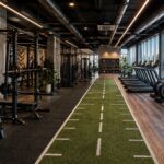Modern gym interior with zoned flooring, fitness equipment and visible ventilation in Dubai